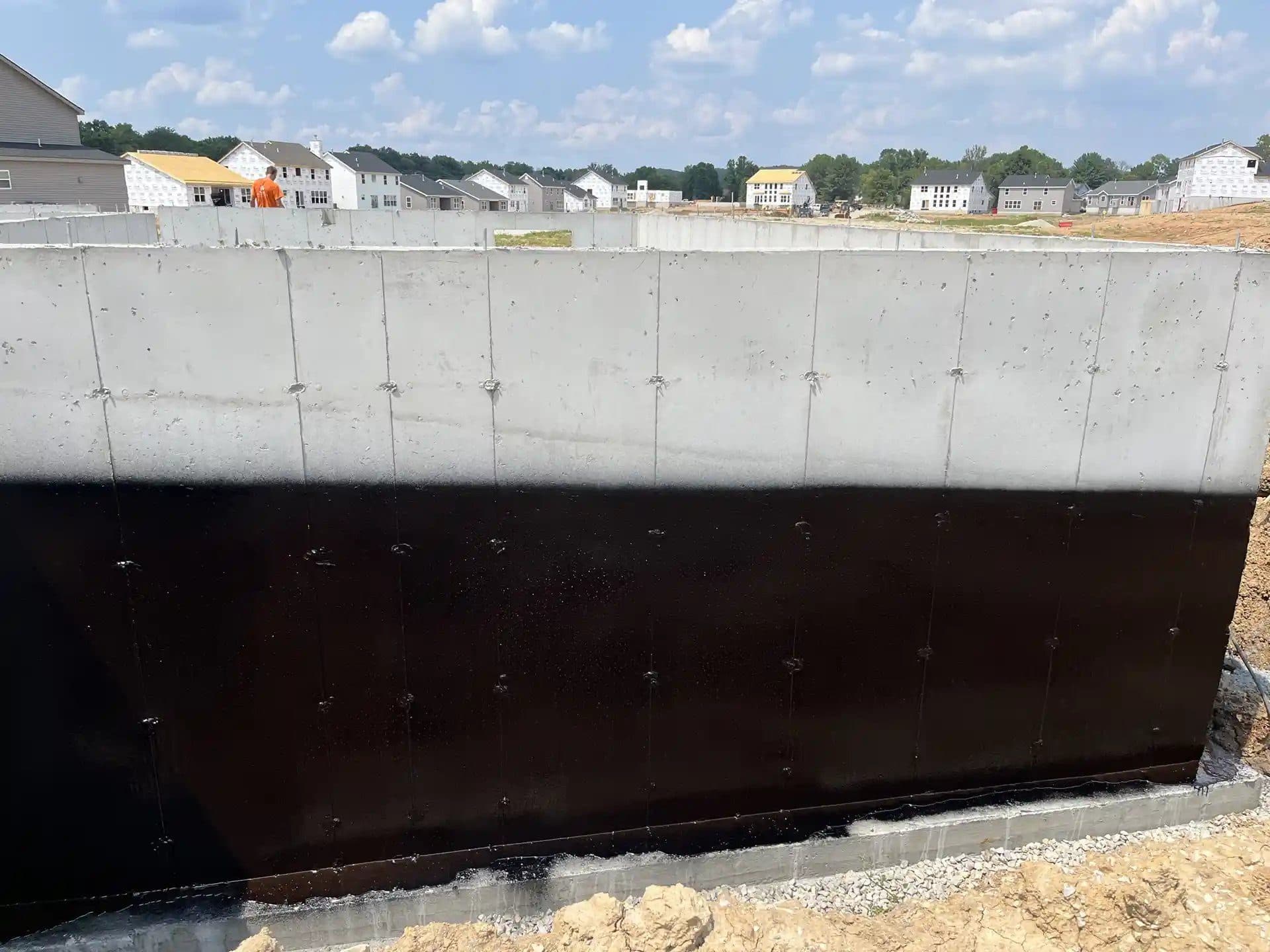Black Rub-R-Proof membrane on a poured concrete production-home wall